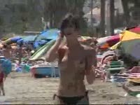 Excellent quality voyeur footage features perfect natural breasted girl topless on the beach